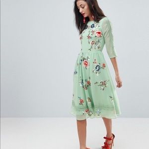 Light green midi dress with floral embroidery.